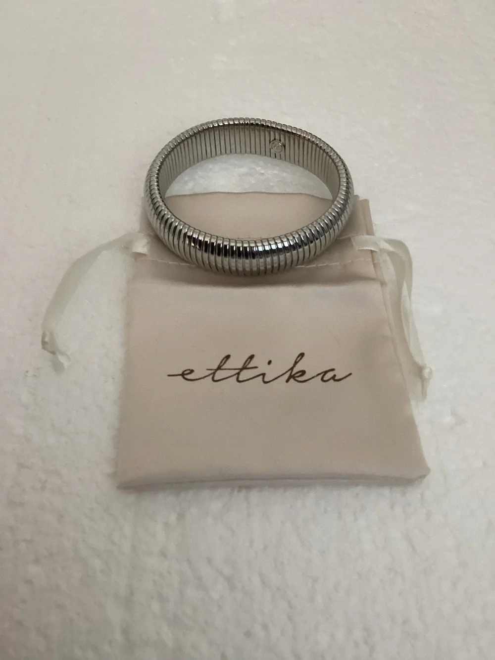 This Ettika silver-plated flexible tubogas-style stretch cuff silver tone brace